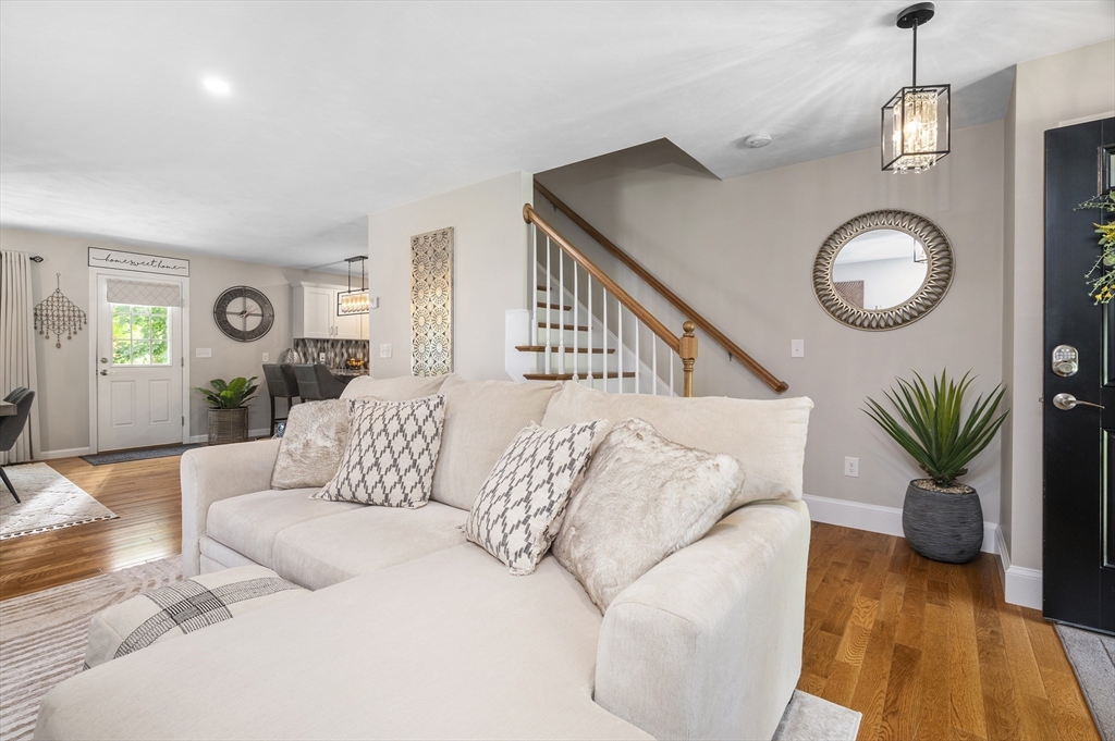 16 Farnum Street, Unit 16 Uxbridge, MA 01569 - Photo 5 of 34 a living room with furniture and a large window
