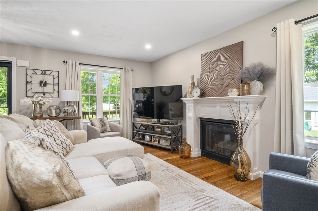 16 Farnum Street, Unit 16 Uxbridge, MA 01569 - Photo 6 of 34 a living room with furniture a flat screen tv and a fireplace