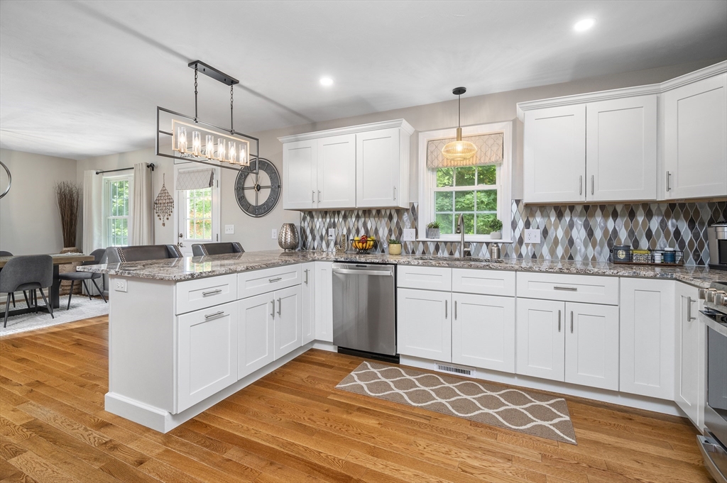 16 Farnum Street, Unit 16 Uxbridge, MA 01569 - Photo 10 of 34 a kitchen with granite countertop white cabinets white appliances a sink and a window