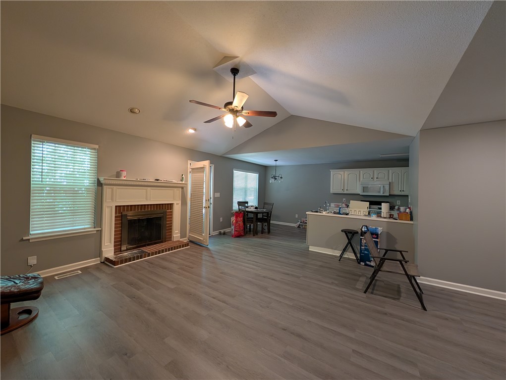 124 Woodbridge Court Anderson, SC 29621 - Photo 13 of 15 This inviting space features a charming fireplace and an open layout connecting to the kitchen area.