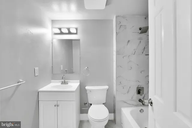 a bathroom with a toilet sink and shower