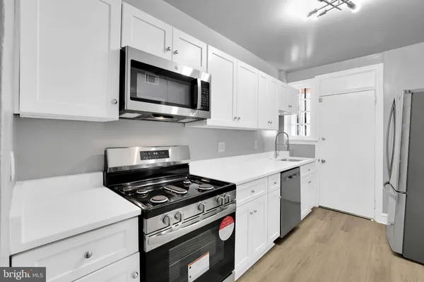 a kitchen with a stove and a microwave