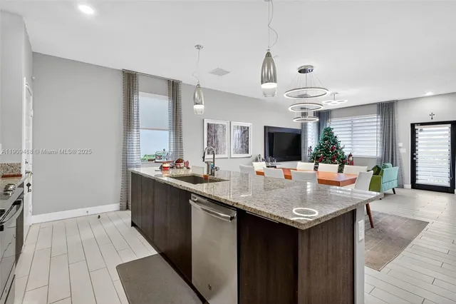 a kitchen with granite countertop cabinets stainless steel appliances and a counter space