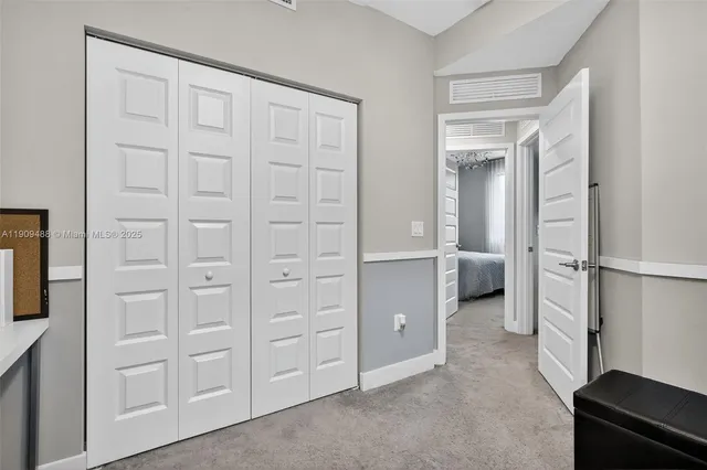 a bed with a black white bedspread and pillows
