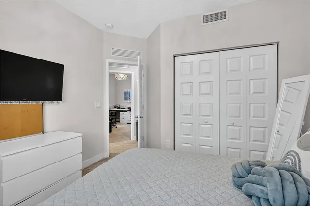 a bedroom with a bed and a chandelier