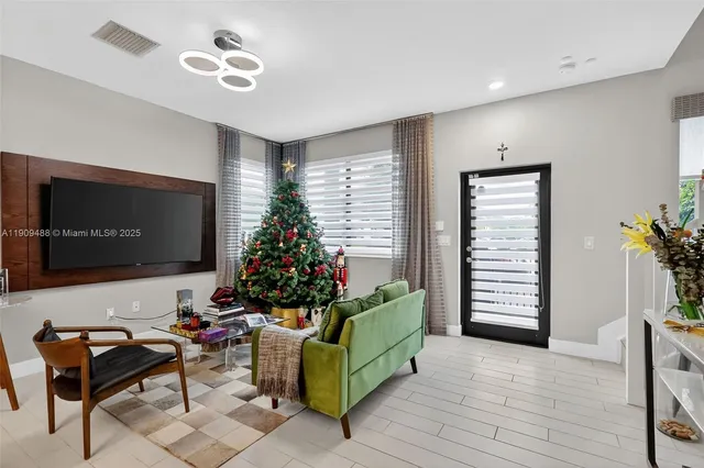 a living room with furniture and a potted plant