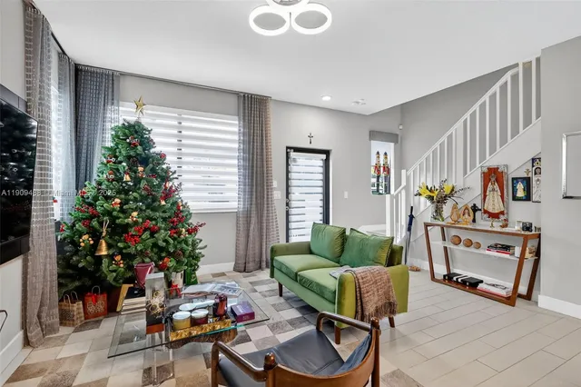 a dining room with wooden floor and a chandelier