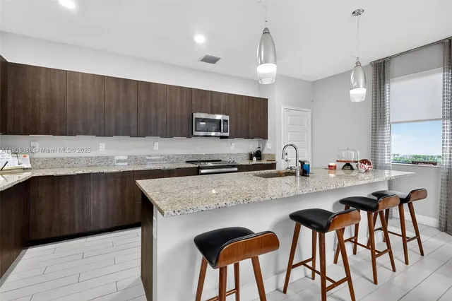 a kitchen with a stove a sink and a refrigerator