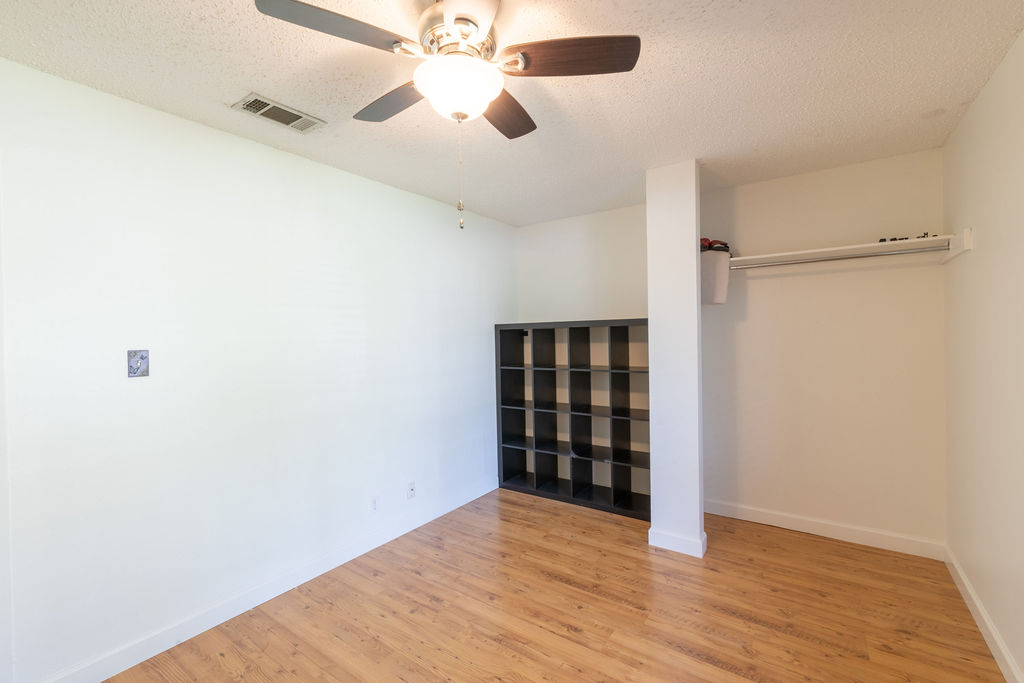 5310 Presidio Road Austin, TX 78745 - Photo 25 of 34 Wood flooring flows through this adaptable room, featuring an overhead ceiling fan for comfort.