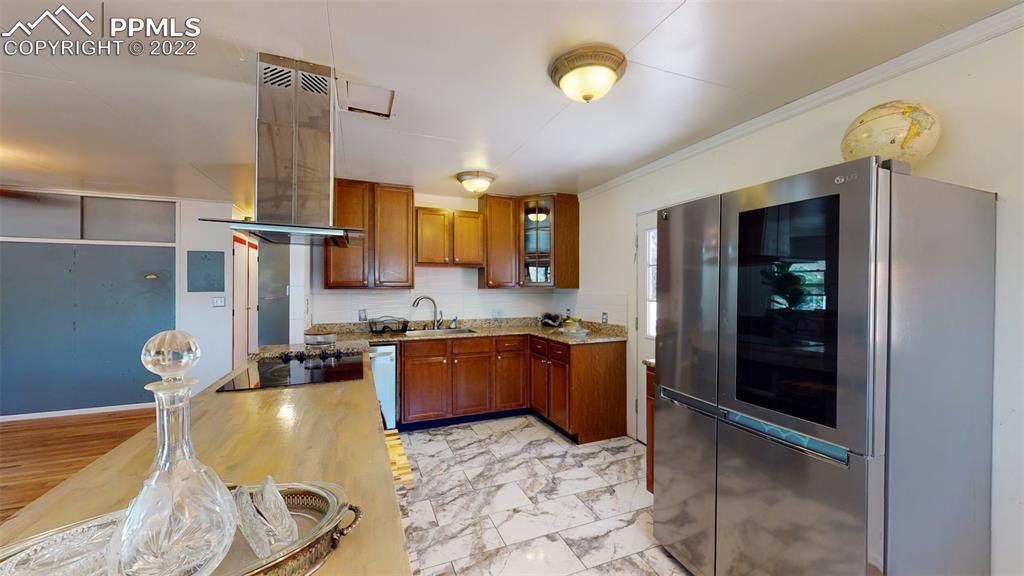 9955 Mesa Road Cascade, CO 80809 - Photo 17 of 30 a kitchen with stainless steel appliances granite countertop a sink and cabinets