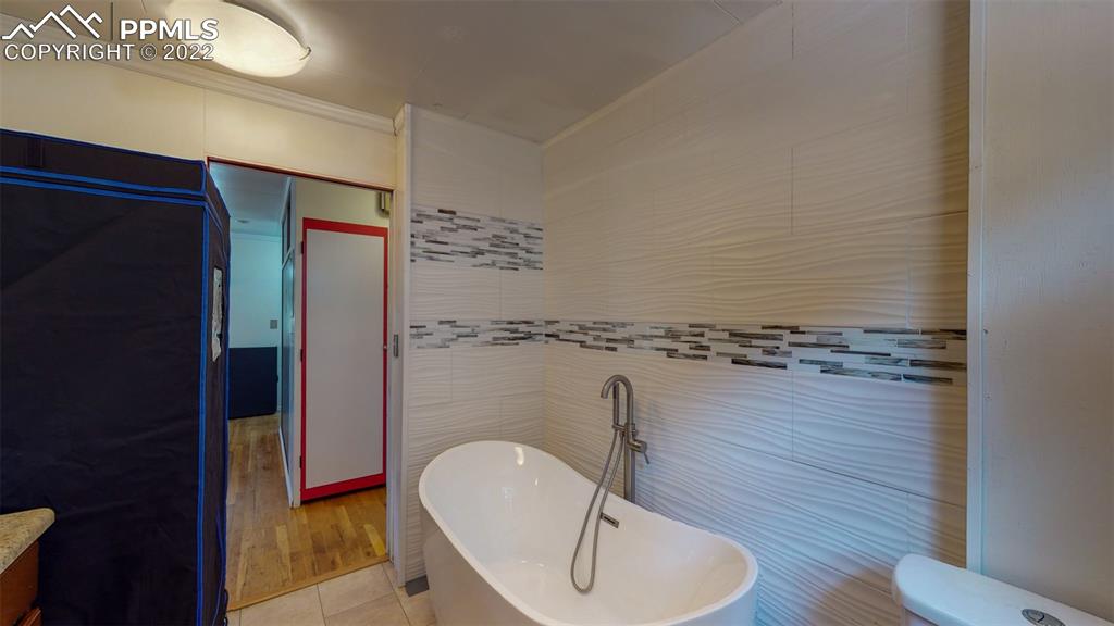 9955 Mesa Road Cascade, CO 80809 - Photo 19 of 30 a bathroom with a sink mirror vanity and toilet