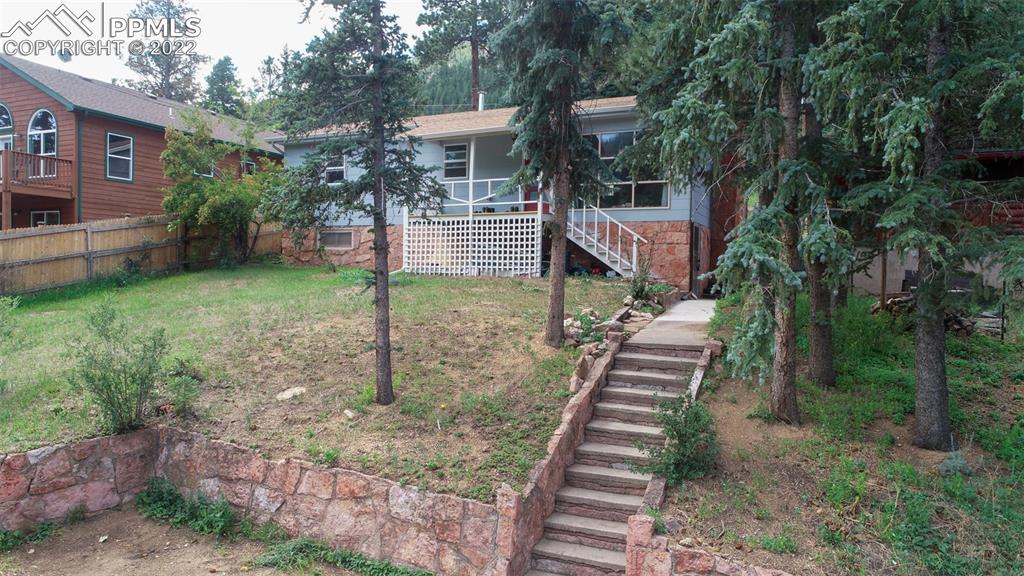 9955 Mesa Road Cascade, CO 80809 - Photo 2 of 30 a front view of a house with a yard