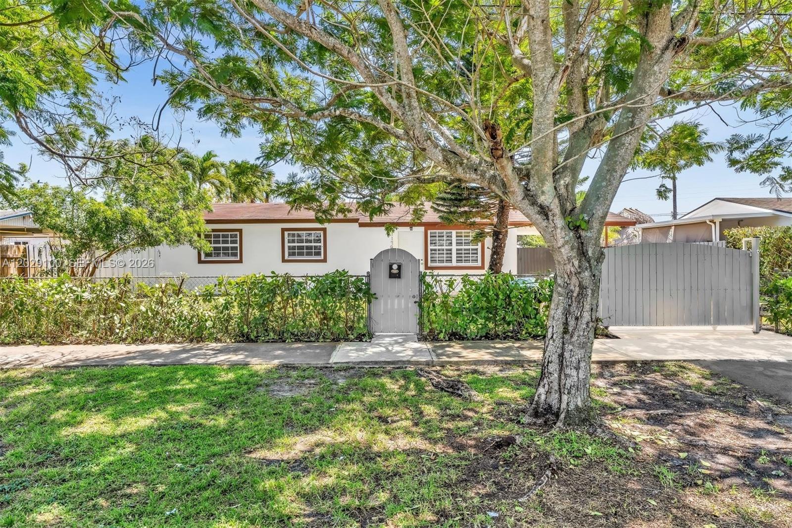 11790 Southwest 34th Street Miami, FL 33175 - Photo 2 of 56 a front view of a house with a yard