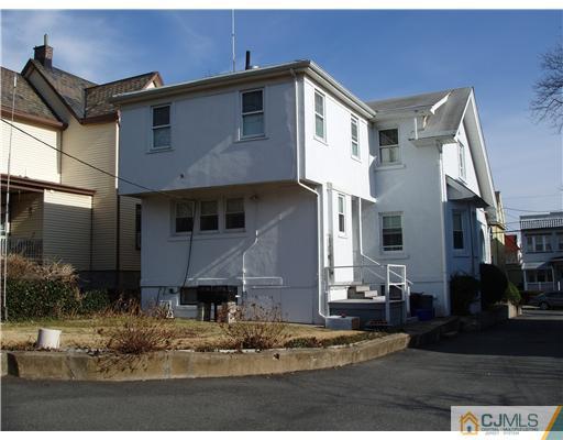 145 Rector Street Perth Amboy, NJ 08861 - Photo 2 of 17 a front view of a house with garden