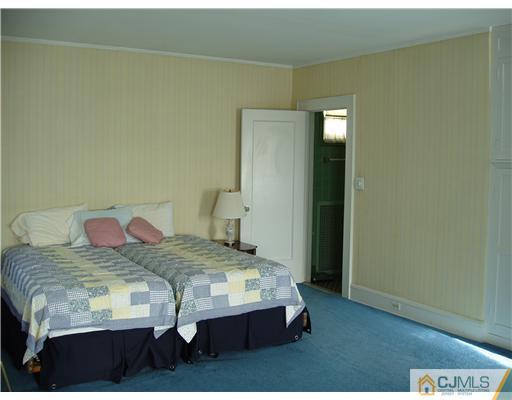 145 Rector Street Perth Amboy, NJ 08861 - Photo 12 of 17 a bedroom with a bed and a table in it