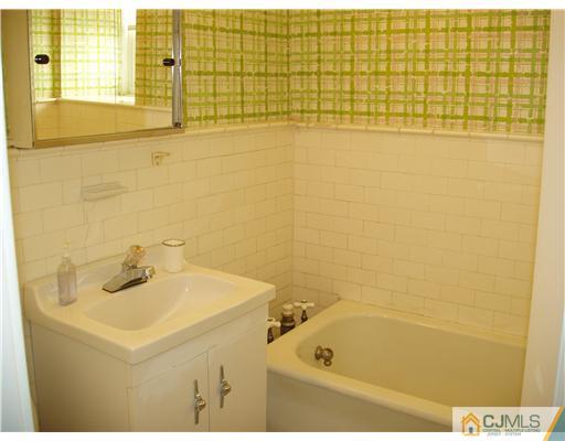 145 Rector Street Perth Amboy, NJ 08861 - Photo 13 of 17 a bathroom with a sink and a bathtub