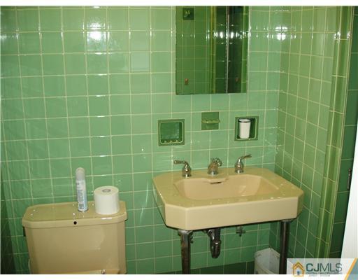 145 Rector Street Perth Amboy, NJ 08861 - Photo 14 of 17 a bathroom with a sink a toilet and shower