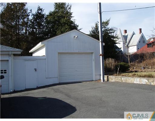 145 Rector Street Perth Amboy, NJ 08861 - Photo 3 of 17 a front view of a house with a yard and garage