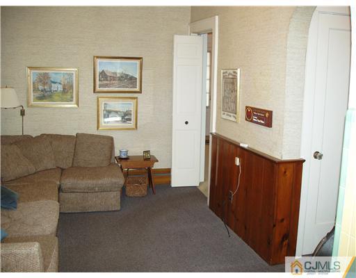 145 Rector Street Perth Amboy, NJ 08861 - Photo 8 of 17 a living room with furniture and a refrigerator
