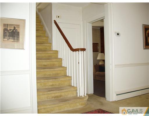 145 Rector Street Perth Amboy, NJ 08861 - Photo 10 of 17 a view of a hallway with wooden floor and staircase