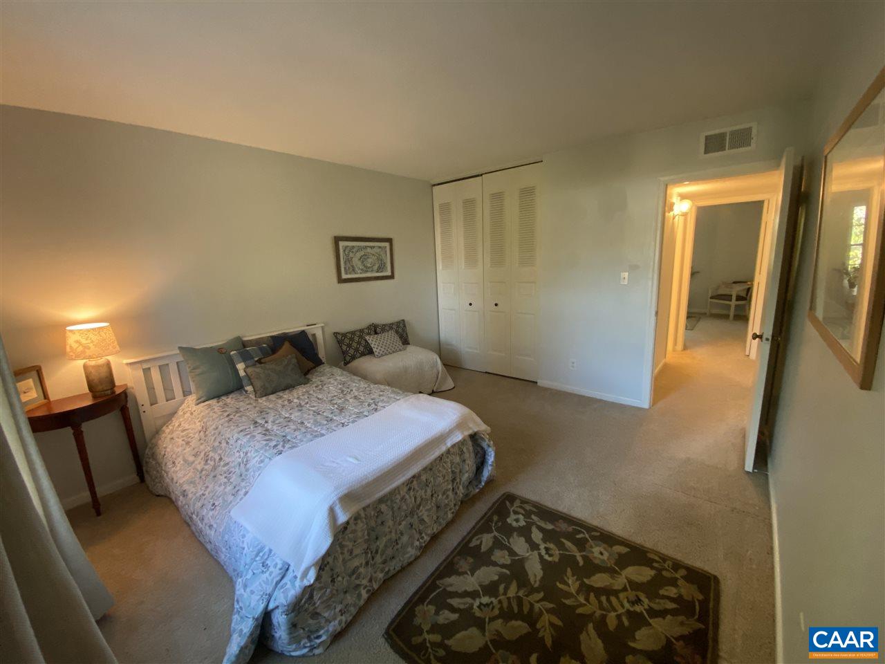 2517 Hydraulic Road, Unit 82 Charlottesville, VA 22901 - Photo 13 of 19 a bedroom with a bed and a mirror