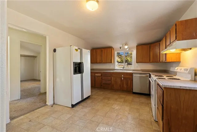 a kitchen with a sink a stove and refrigerator