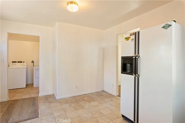 a view of a kitchen with a sink and refrigerator
