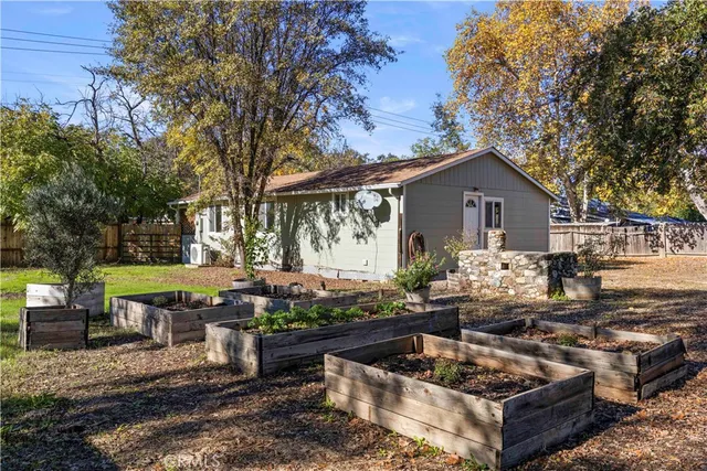 a view of a house with patio chairs and a fire pit