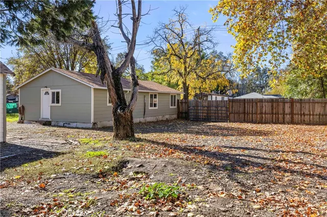 a tree in front of a white house