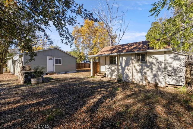 a view of a house with a tree in the yard