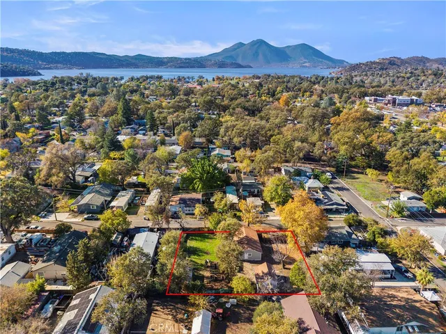 an aerial view of residential houses with city view