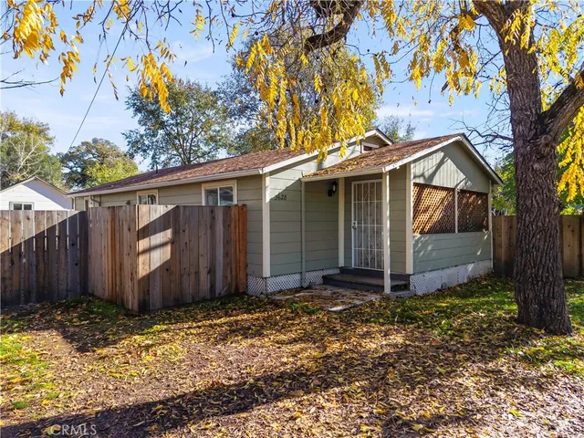 a view of a house with a tree in the yard