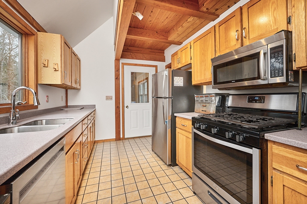 130 Coles Meadow Road Northampton, MA 01060 - Photo 12 of 42 a kitchen with stainless steel appliances granite countertop a stove a sink and a microwave