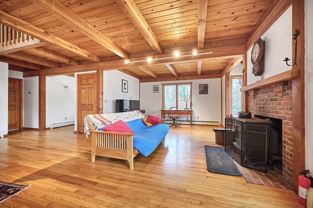 130 Coles Meadow Road Northampton, MA 01060 - Photo 7 of 42 a living room with fireplace furniture and a wooden floor