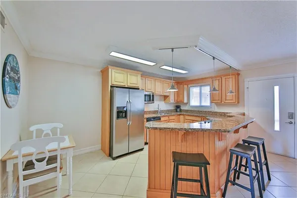 a kitchen that has a table and chairs in it
