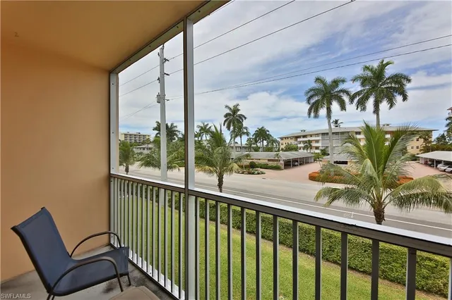 a view of a balcony with potted plants
