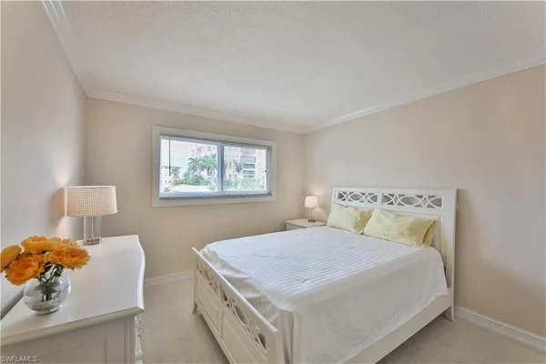 a bedroom with a bed and a lamp on table