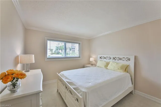 a bedroom with a bed and a lamp on table