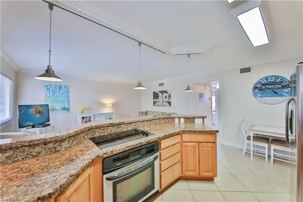 a kitchen with a stove a sink and a refrigerator