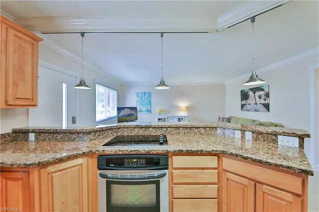 a kitchen with granite countertop a sink stainless steel appliances and cabinets