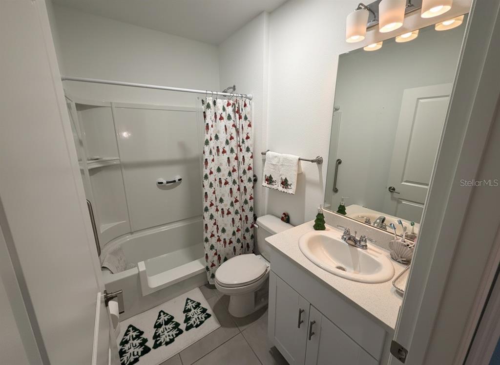 9611 Rampart Road Leesburg, FL 34788 - Photo 12 of 24 a bathroom with a sink toilet a mirror and shower