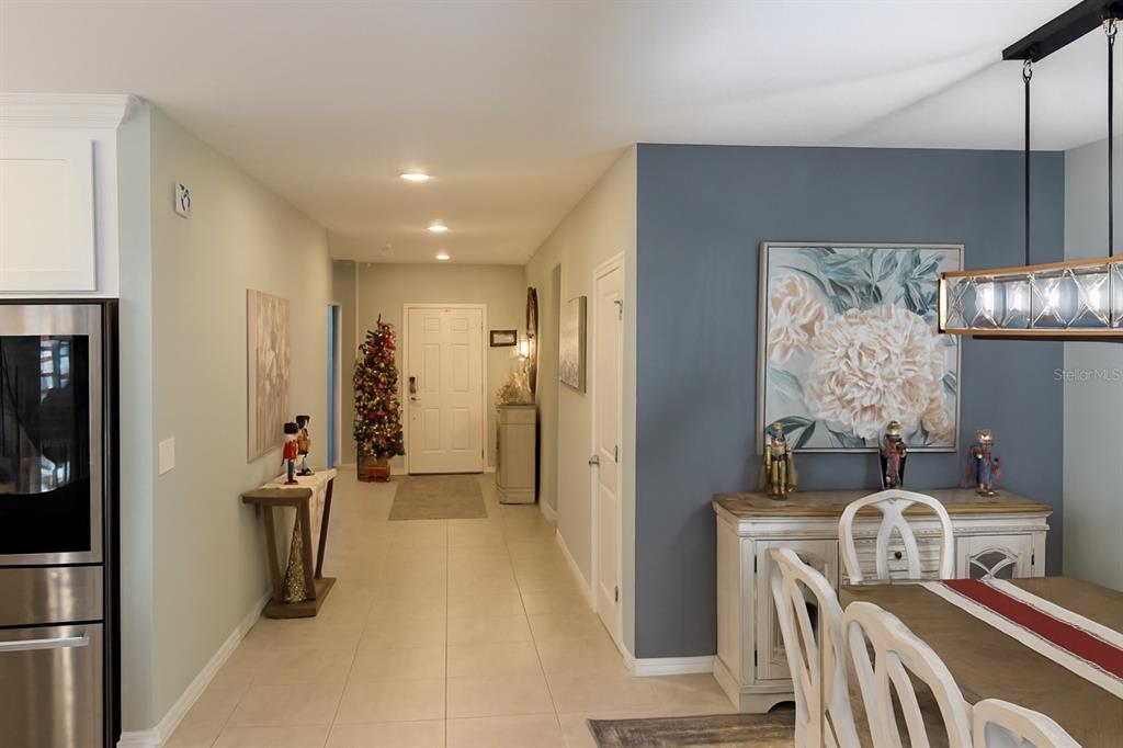 9611 Rampart Road Leesburg, FL 34788 - Photo 13 of 24 a view of a hallway with furniture and refrigerator