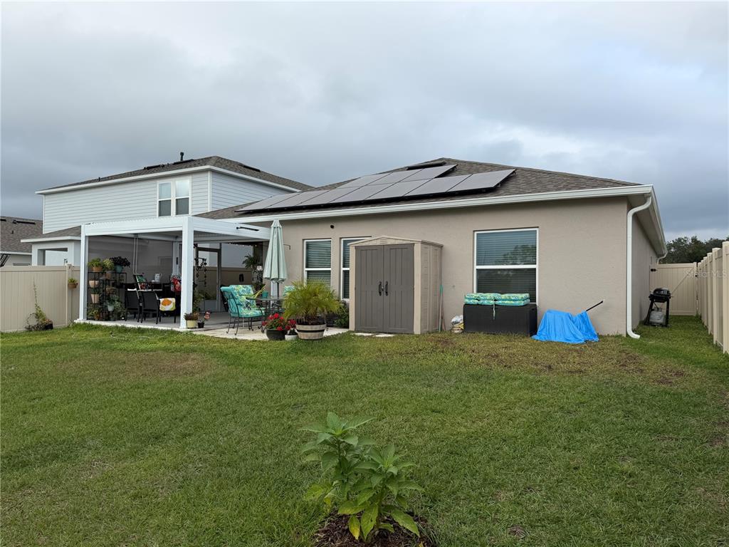 9611 Rampart Road Leesburg, FL 34788 - Photo 23 of 24 a view of a house with backyard porch and garden