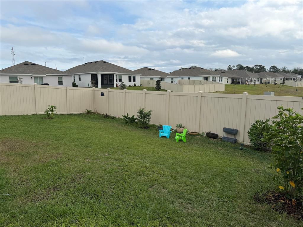 9611 Rampart Road Leesburg, FL 34788 - Photo 24 of 24 a view of a house with a yard and a garden