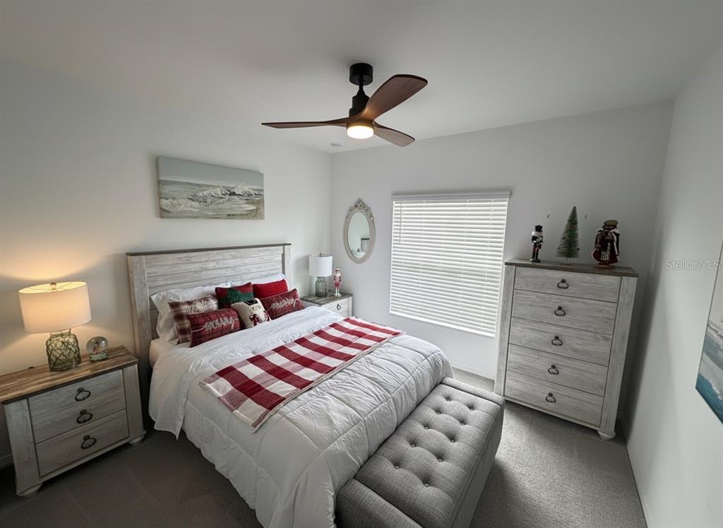 9611 Rampart Road Leesburg, FL 34788 - Photo 5 of 24 a bedroom with a bed and a chandelier