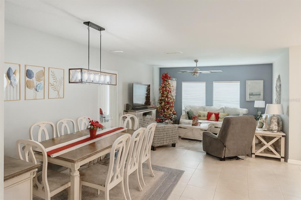 9611 Rampart Road Leesburg, FL 34788 - Photo 9 of 24 a living room with furniture and a chandelier