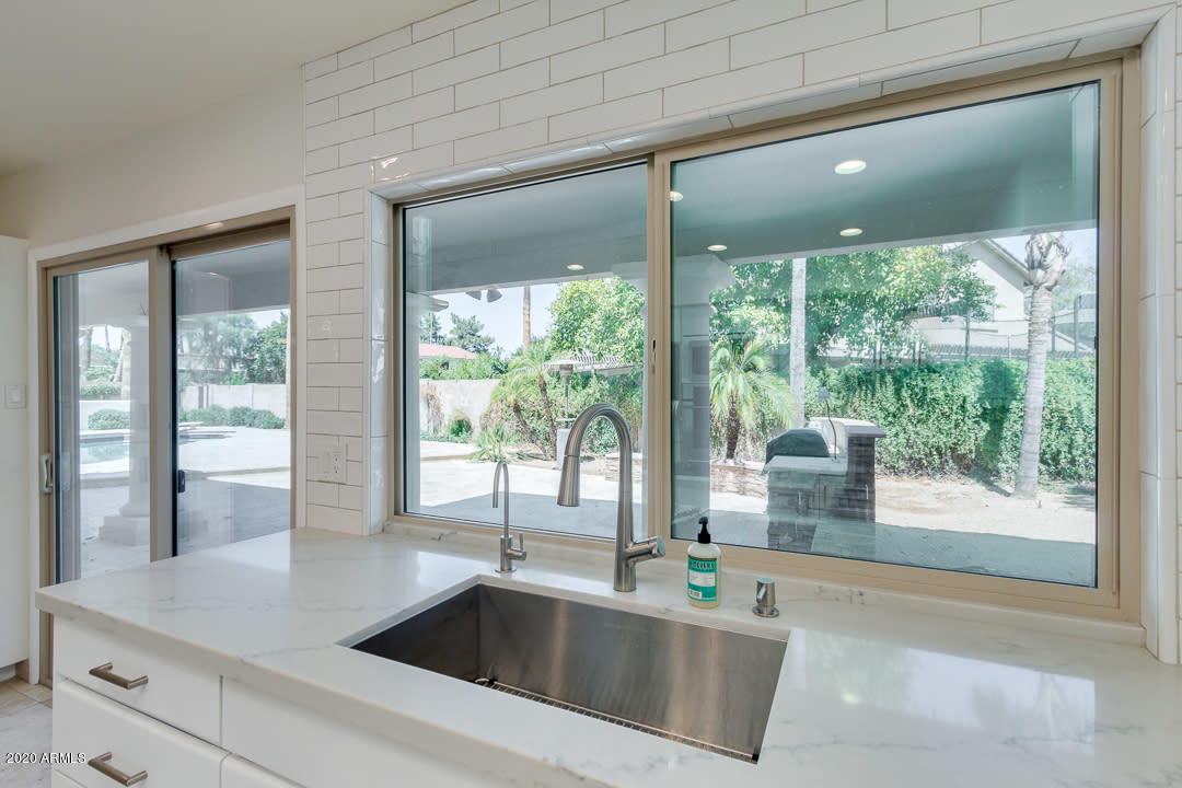 7475 East Raintree Court Scottsdale, AZ 85258 - Photo 12 of 38 a kitchen with a large window and sink