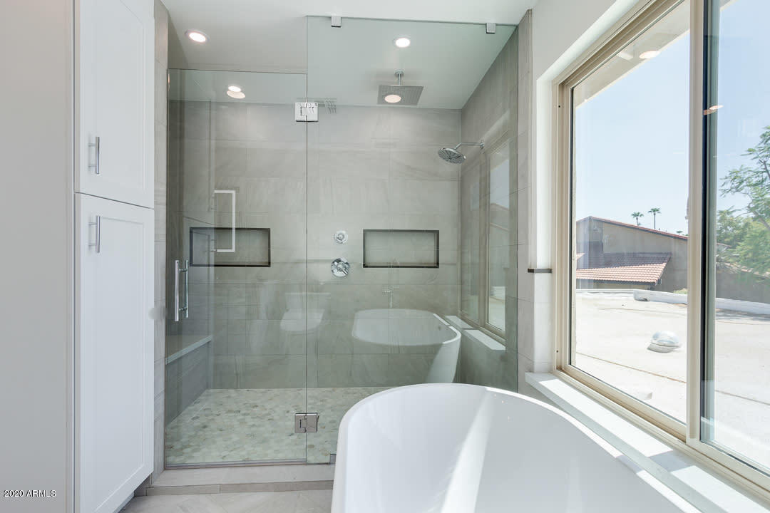 7475 East Raintree Court Scottsdale, AZ 85258 - Photo 17 of 38 a bathroom with a bathtub and a shower
