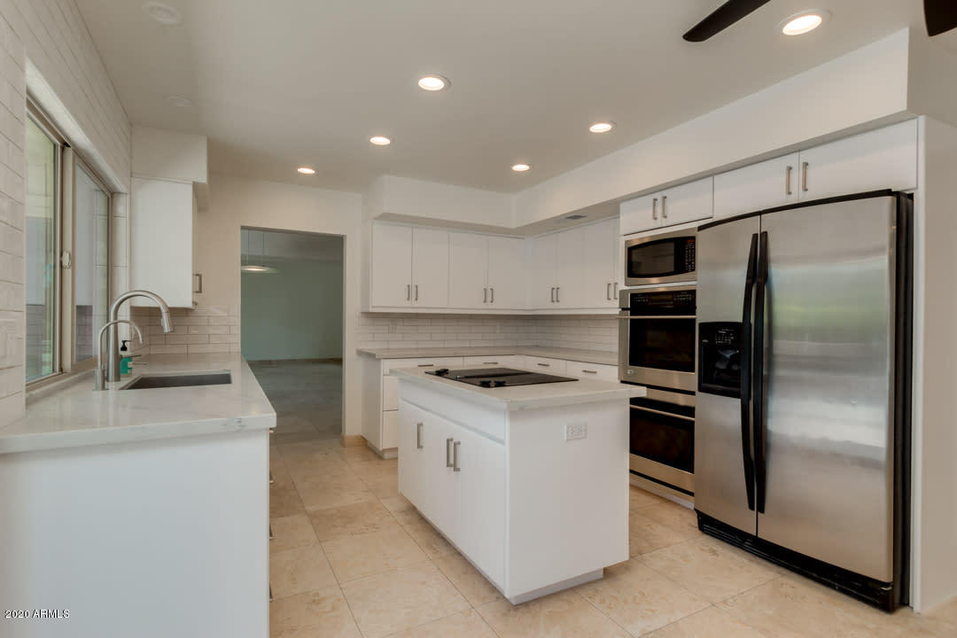 7475 East Raintree Court Scottsdale, AZ 85258 - Photo 2 of 38 a kitchen with a refrigerator sink and stove