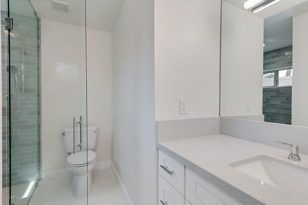 7475 East Raintree Court Scottsdale, AZ 85258 - Photo 22 of 38 a bathroom with a granite countertop sink toilet and shower